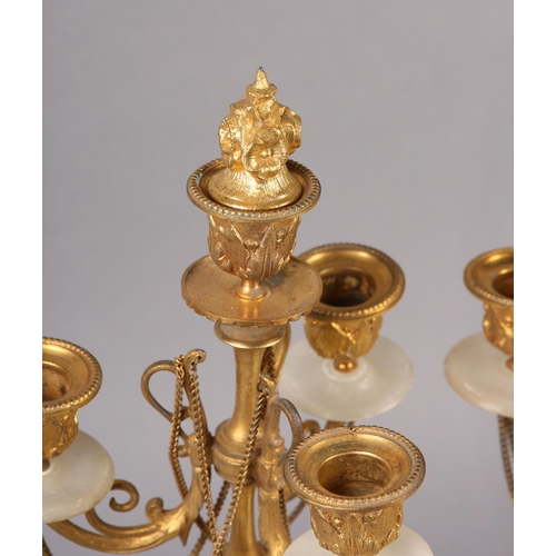 30 - PAIR OF GILT AND ALABASTER FOUR LIGHT CANDELABRAS, foliage sconces supported by scrolled arms with f... 