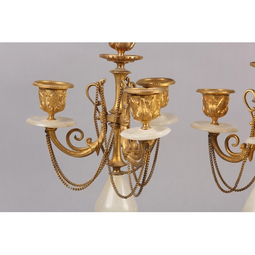 30 - PAIR OF GILT AND ALABASTER FOUR LIGHT CANDELABRAS, foliage sconces supported by scrolled arms with f... 