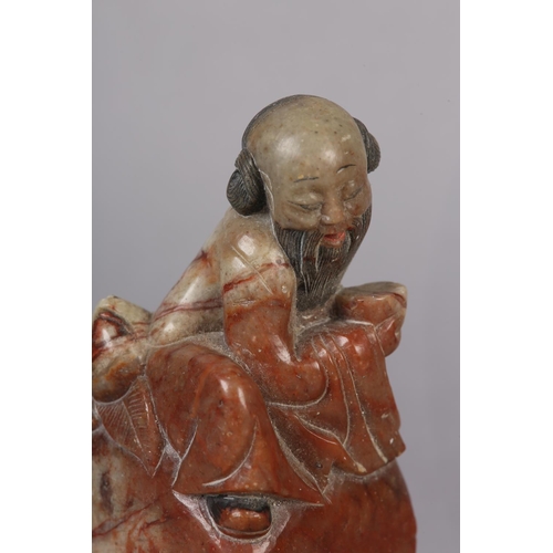 111 - A CHINESE CARVED MARBLE FIGURE OF SHOU LAO, God of longevity sitting with peach and cup, raised on a... 