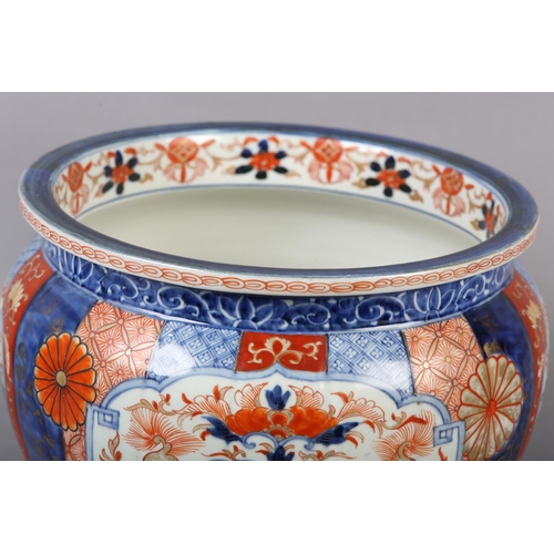 114 - A CHINESE IMARI JARDINIERE, the lobed body painted with alternating panels of scrollwork, diaper cel... 