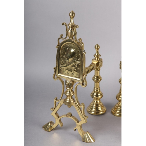 44 - A PAIR OF AESTHETIC MOVEMENT BRASS FIRE DOGS, each with an arched panel worked with a robin perched ... 