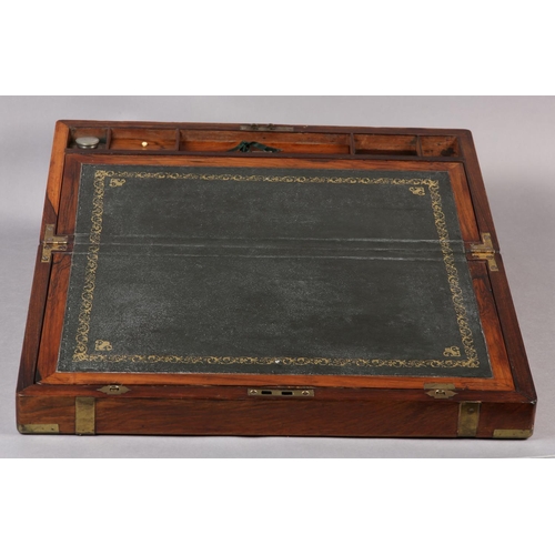 77 - A MID 19TH CENTURY ROSEWOOD AND BRASS BOUND WRITING BOX, the interior fitted with leather incised wr... 