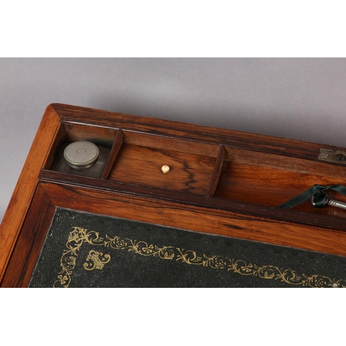 77 - A MID 19TH CENTURY ROSEWOOD AND BRASS BOUND WRITING BOX, the interior fitted with leather incised wr... 