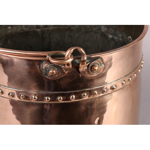 47 - AN EARLY 20TH CENTURY COPPER LOG BUCKET, cylindrical with swing handle and studded seams, 34cm diame... 