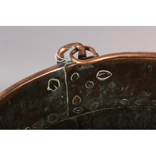 47 - AN EARLY 20TH CENTURY COPPER LOG BUCKET, cylindrical with swing handle and studded seams, 34cm diame... 