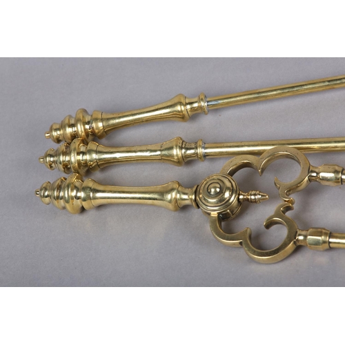 48 - A MID 19TH CENTURY SET OF THREE BRASS FIRE IRONS having baluster turned handles and knop finials com... 