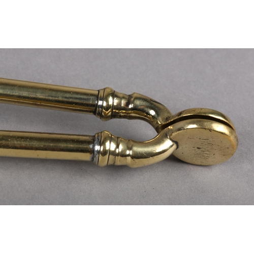 48 - A MID 19TH CENTURY SET OF THREE BRASS FIRE IRONS having baluster turned handles and knop finials com... 