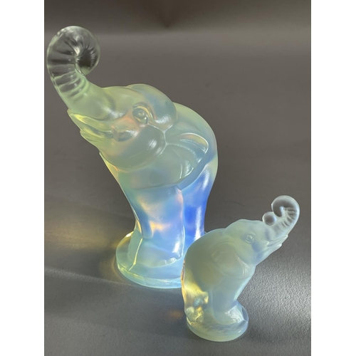 134 - A SABINO OPALESCENT GLASS ELEPHANT CAR MASCOT, with trunk raised on circular plinth base, 11cm high ... 