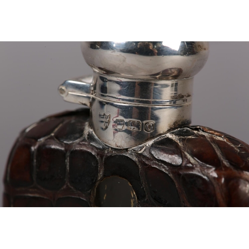 152 - A GEORGE VI SILVER AND CROCODILE SKIN COVERED GLASS SPIRIT FLASK, Sheffield 1949, 11cm high