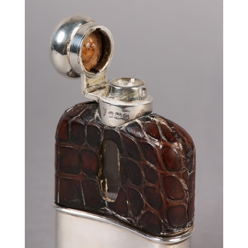 152 - A GEORGE VI SILVER AND CROCODILE SKIN COVERED GLASS SPIRIT FLASK, Sheffield 1949, 11cm high