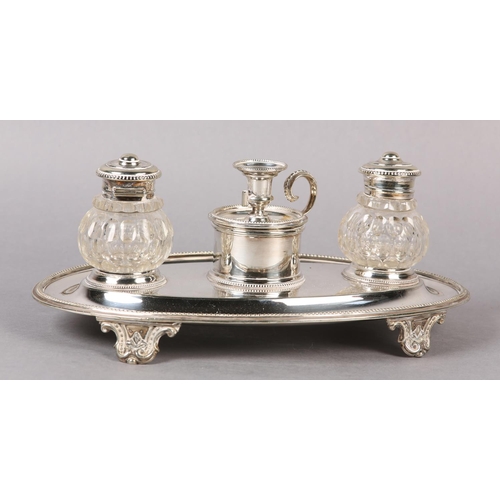 148 - AN ELKINGTON AND CO SILVER PLATED DESK STANDISH of oval outline, fitted with a chamberstick flanked ... 