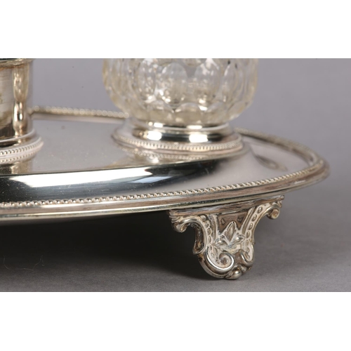 148 - AN ELKINGTON AND CO SILVER PLATED DESK STANDISH of oval outline, fitted with a chamberstick flanked ... 