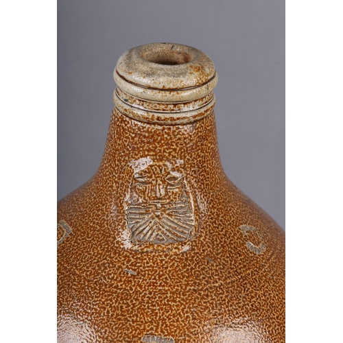 95 - A LATE 17TH/EARLY 18TH CENTURY RHENISH BELLARMINE of typical form, salt glaze stoneware, impressed t... 