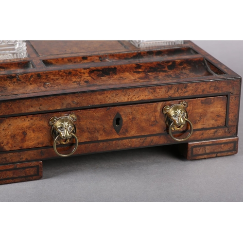 75 - A LATE REGENCY BURR WALNUT DESK STANDISH INLAID WITH EBONY STRINGING, fitted with two square-cut gla... 