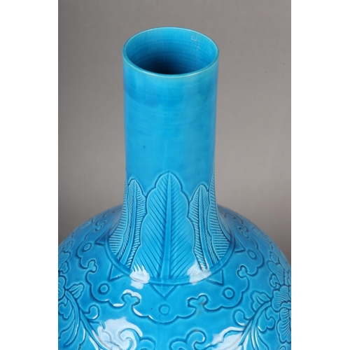 115 - A CHINESE TURQUOISE GLAZED VASE, the elongated neck incised with a band of stiff leaves above a roun... 