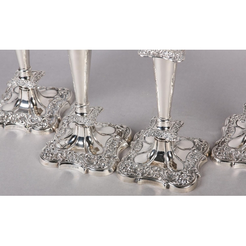 158 - A SET OF FOUR GEORGE V SILVER CANDLESTICKS, Chester 1910 Herbert Edward and Frank Ernest Barker, hav... 