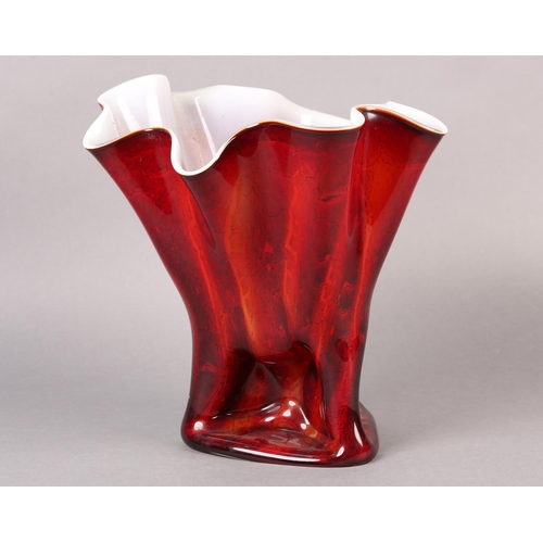 145 - A GLASS VASE OF FAZZOLETTO FORM the exterior in reds and oranges with white interior, the glass pinc... 