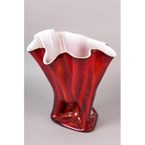 145 - A GLASS VASE OF FAZZOLETTO FORM the exterior in reds and oranges with white interior, the glass pinc... 