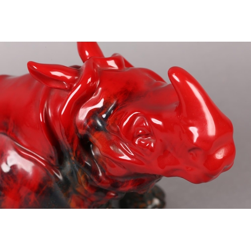 87 - A ROYAL DOULTON VEINED FLAMBE RHINO, modelled in recumbent position, marked to the base with stamp i... 