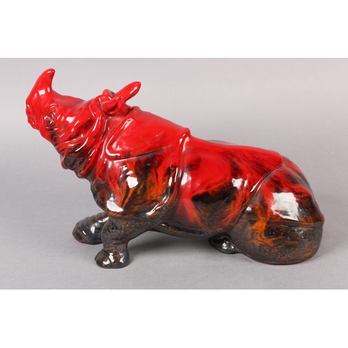 87 - A ROYAL DOULTON VEINED FLAMBE RHINO, modelled in recumbent position, marked to the base with stamp i... 