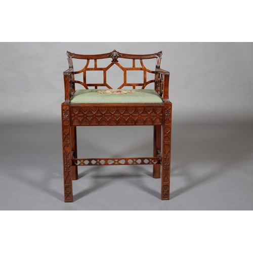 376 - A CHINESE CHIPPENDALE REVIVAL mahogany dressing stool, having a low fretwork back and side panels, n... 