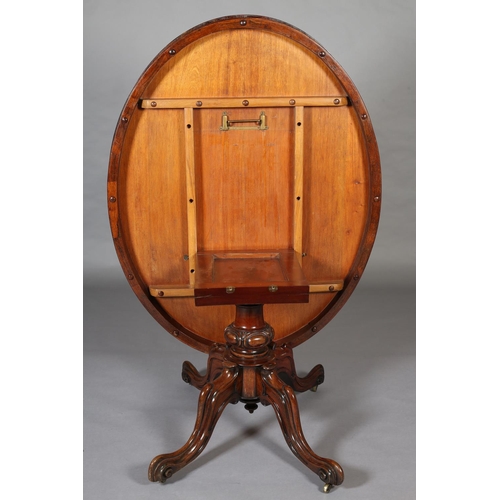 387 - A VICTORIAN LOOE TABLE, having an oval tilt top, on short lobed column and quadruple base with hippe... 