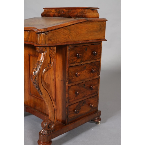 389 - A MID VICTORIAN WALNUT DAVENPORT, with raised stationery compartment, leather incised fall front of ... 