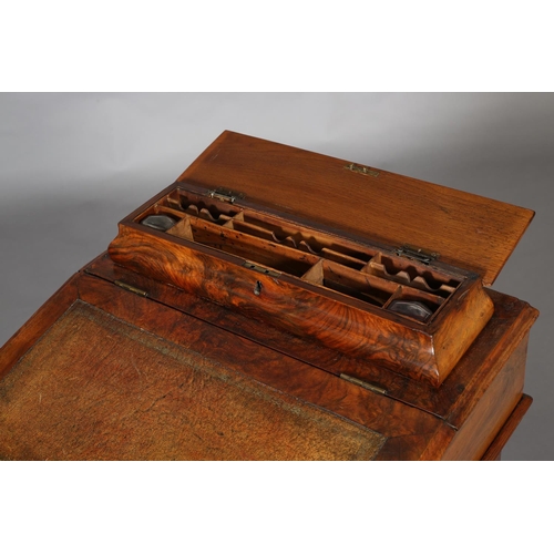 389 - A MID VICTORIAN WALNUT DAVENPORT, with raised stationery compartment, leather incised fall front of ... 