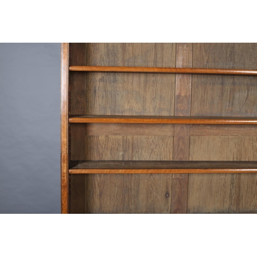 364 - A MID-19TH CENTURY FIGURED WALNUT BOOKCASE-CUPBOARD, having a moulded cornice above three open shelv... 