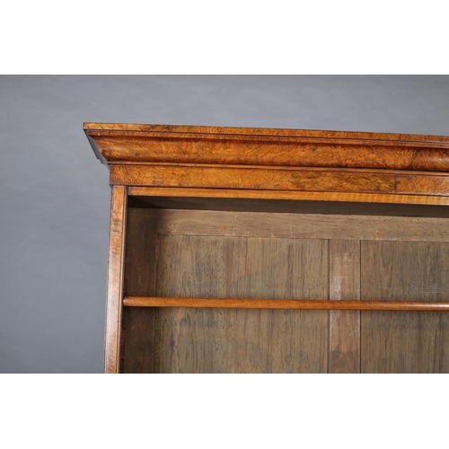 364 - A MID-19TH CENTURY FIGURED WALNUT BOOKCASE-CUPBOARD, having a moulded cornice above three open shelv... 