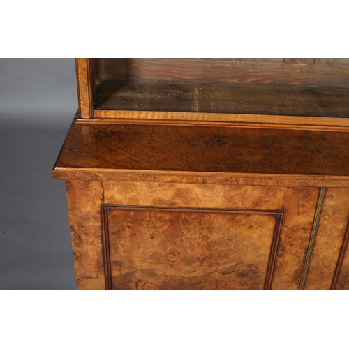 364 - A MID-19TH CENTURY FIGURED WALNUT BOOKCASE-CUPBOARD, having a moulded cornice above three open shelv... 