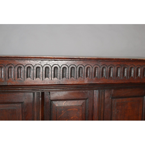 428 - AN OAK COURT CUPBOARD, 17th century and later having an arcaded frieze above a recessed cupboard of ... 