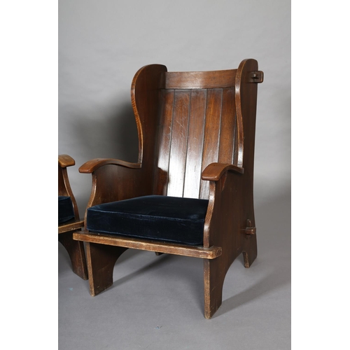 415 - A PAIR OF MID-20TH CENTURY ARTS & CRAFTS STYLE ELM WINGED ARMCHAIRS, having a pegged planked back, c... 