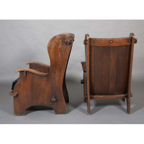 415 - A PAIR OF MID-20TH CENTURY ARTS & CRAFTS STYLE ELM WINGED ARMCHAIRS, having a pegged planked back, c... 