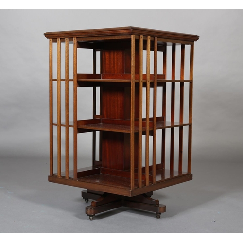 405 - AN EARLY 20th CENTURY MAHOGANY REVOLVING BOOKCASE of three tiers and railed panels on quadruple plat... 