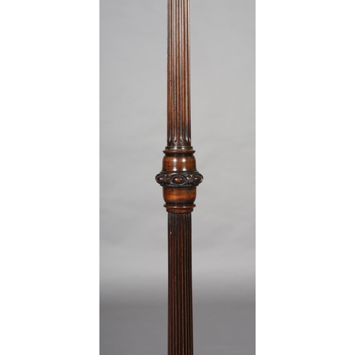 404 - AN EARLY 20th CENTURY MAHOGANY STANDARD LAMP on a fluted and reeded column with lobed collar, on tri... 