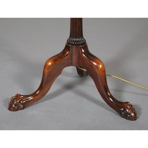 404 - AN EARLY 20th CENTURY MAHOGANY STANDARD LAMP on a fluted and reeded column with lobed collar, on tri... 