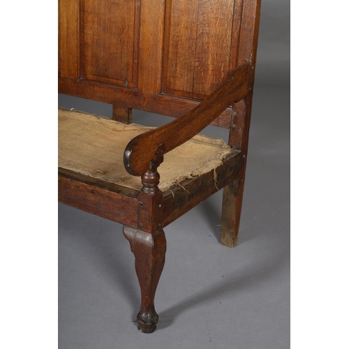 424 - A GEORGE III OAK SETTLE OF SMALL PROPORTIONS having a triple field panel back, slab arms, on cabriol... 