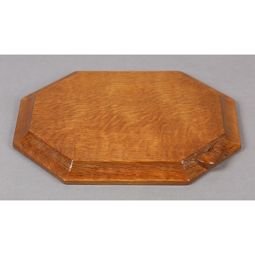 359 - A THOMPSON OF KILBURN 'MOUSEMAN' OAK BREAD OR CHEESE BOARD, of irregular octagonal form, the chamfer... 