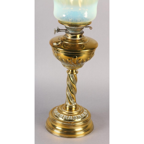 14 - A VICTORIAN BRASS OIL LAMP, with wrythen lobed reservoir and wrythen column on circular stepped base... 