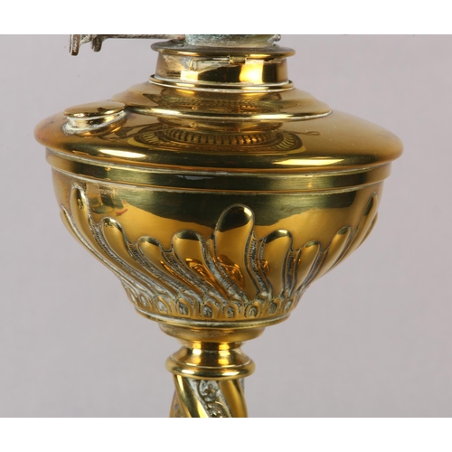 14 - A VICTORIAN BRASS OIL LAMP, with wrythen lobed reservoir and wrythen column on circular stepped base... 