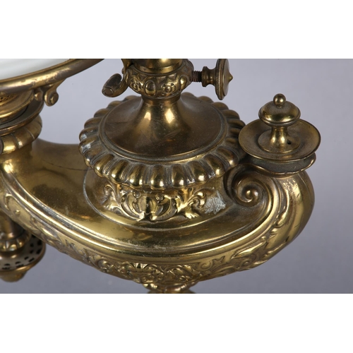 18 - A VICTORIAN BRASS ALADDIN'S TYPE OIL LAMP cast, with flowering scrolls with gadroon rims, with heigh... 