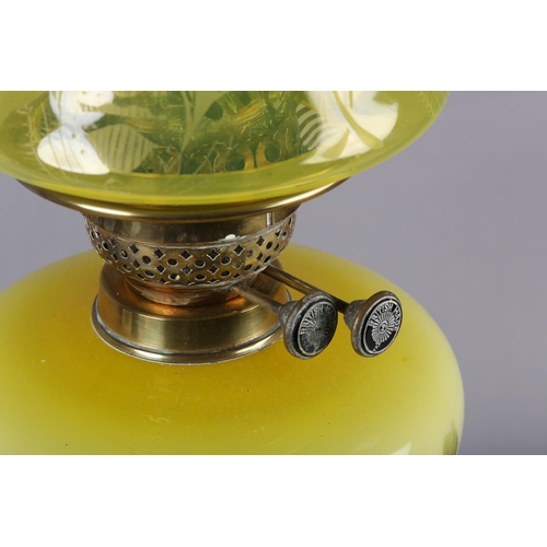 22 - A VICTORIAN BRASS REEDED COLUMN OIL LAMP, the tinted yellow glass reservoir painted with flowers, on... 