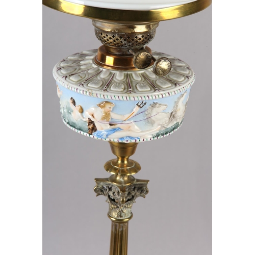 23 - A VICTORIAN BRASS COLUMN OIL LAMP having an Italian Naples style reservoir moulded with a continuous... 