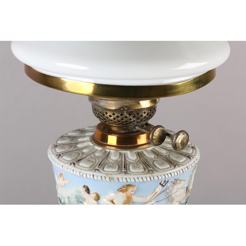 23 - A VICTORIAN BRASS COLUMN OIL LAMP having an Italian Naples style reservoir moulded with a continuous... 