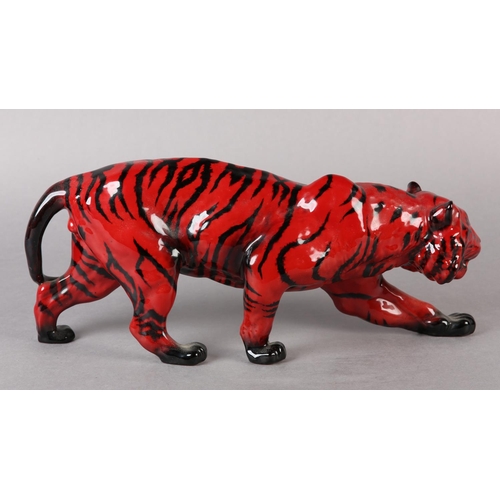 89 - A ROYAL DOULTON VEINED FLAMBE FIGURE OF A TIGER, modelled stalking, marked to the front left paw wit... 