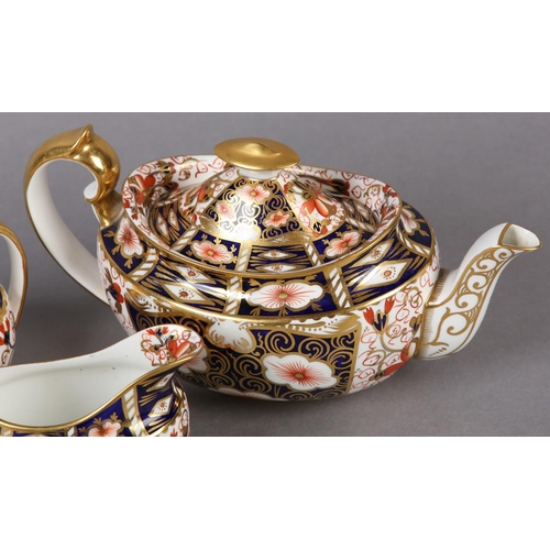 98 - A ROYAL CROWN DERBY IMARI TEA SERVICE comprising teapot and milk jug dated 1909 and twin handled sug... 