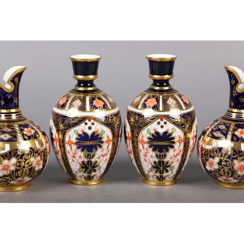 99 - A PAIR OF ROYAL CROWN DERBY IMARI PATTERN EWERS with moulded gilt handles together with a pair of wa... 