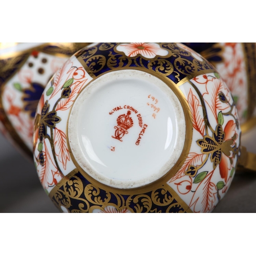 99 - A PAIR OF ROYAL CROWN DERBY IMARI PATTERN EWERS with moulded gilt handles together with a pair of wa... 