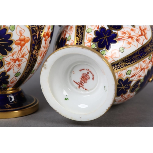 100 - A PAIR OF ROYAL CROWN DERBY IMARI PATTERN urn vases with date cyphers for 1925 together with a lidde... 